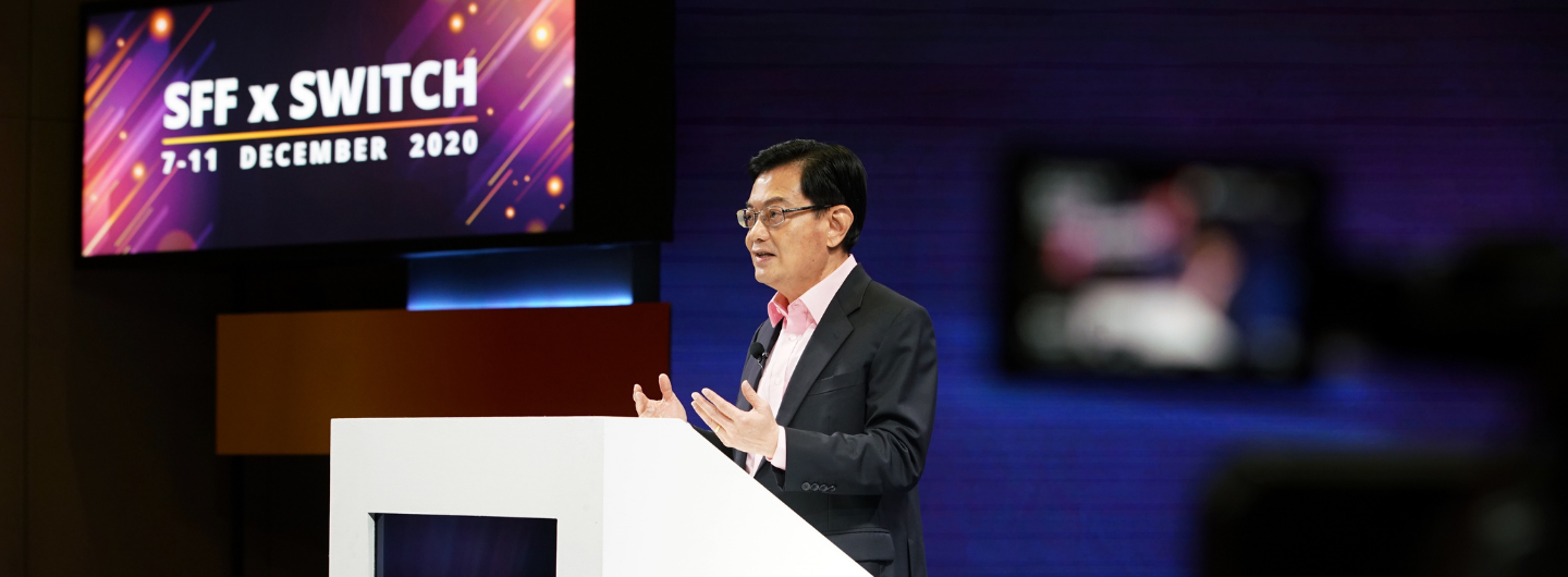 Man at podium giving speech, SFFxSWITCH 7-11 Dec 2020 on screen.